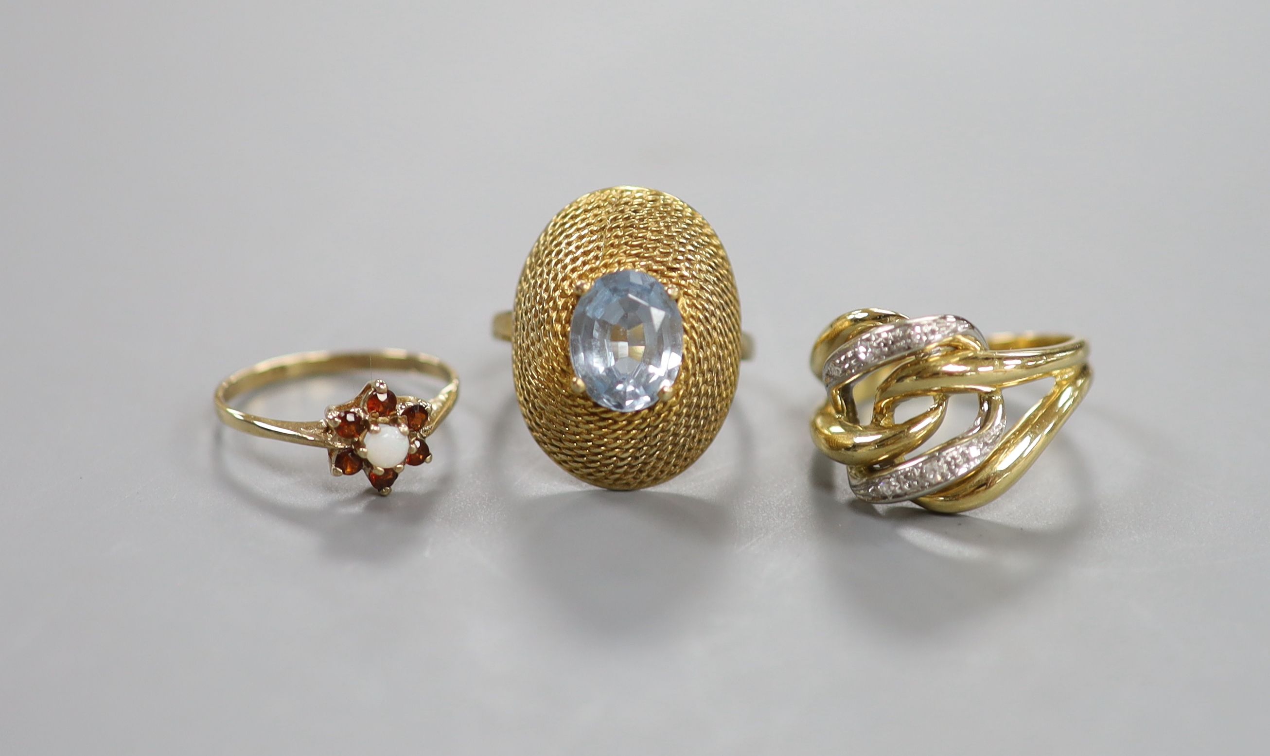 A modern 750 yellow metal and diamond chip set dress ring, size O, gross 6.6 grams and two other yellow metal and gem set rings, gross 7.3 grams.